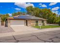 Charming single-Gathering home with solar panels, green lawn, and a two-car garage at 3556 E Angela Dr, Phoenix, AZ 85032