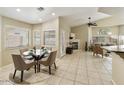 Bright dining area with a glass table, tile flooring, natural light, and open-concept design at 4202 E Broadway Rd # 40, Mesa, AZ 85206
