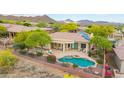 Backyard view of a home with a covered patio, a pool, and desert landscaping in a golf community at 42102 N Long Cove Way, Phoenix, AZ 85086