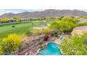 Overhead view of a refreshing pool and landscaping overlooking a lush green golf course at 42102 N Long Cove Way, Phoenix, AZ 85086