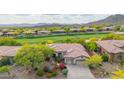 Beautiful aerial view of a home with a tile roof and a well-manicured yard, nestled in a golf course community at 42102 N Long Cove Way, Phoenix, AZ 85086