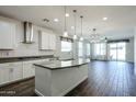 Open-concept kitchen featuring sleek countertops, modern appliances, and wood-style flooring at 4336 E Mesquite St, Gilbert, AZ 85296