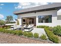 Spacious outdoor patio with plush seating, a fire pit, and manicured landscaping providing a relaxing retreat at 4502 E Solano Dr, Phoenix, AZ 85018