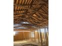 View of the home's interior featuring wood beams and stud framing at 509 W 12Th St, Casa Grande, AZ 85122