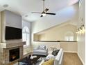 Bright living room boasts a fireplace, ceiling fan, and ample natural light from the arched windows at 5640 E Bell Rd # 1098, Scottsdale, AZ 85254