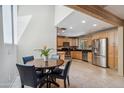 Open kitchen and dining area with stainless steel appliances and ample cabinet space at 6611 E Voltaire Ave, Scottsdale, AZ 85254