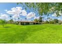 A spacious yard with green grass and mature trees providing plenty of shade and privacy at 7646 E Miami Rd, Scottsdale, AZ 85258