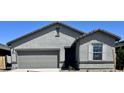 Contemporary home design with a gray color scheme, featuring a two-car garage and desert landscaping at 13254 E Verbina Ln, Florence, AZ 85132