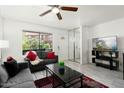 Bright living room with modern decor, including a ceiling fan, and comfortable seating at 14203 N 19Th Ave # 1031, Phoenix, AZ 85023