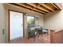 A cozy porch with a table and chairs awaits guests at the front door at 14203 N 19Th Ave # 1031, Phoenix, AZ 85023