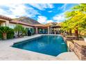 Expansive backyard with a large pool, waterfall, and outdoor living space, perfect for relaxation and recreation at 16201 S 29Th Ave, Phoenix, AZ 85045