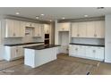 Bright kitchen features white cabinets, dark countertops, and a large island with lots of storage at 1913 W Lariat Ln, Phoenix, AZ 85085