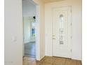 Bright and welcoming entryway with a decorative glass front door and views into the open floor plan at 20455 N Lemon Drop Dr, Maricopa, AZ 85138