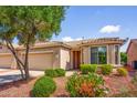 Charming single-story home with a well-maintained front yard, desert landscaping, and a two-car garage at 20455 N Lemon Drop Dr, Maricopa, AZ 85138