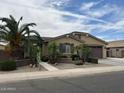 Charming single-story home with a desert landscaped yard and two car garage at 2585 E Carob Dr, Gilbert, AZ 85298