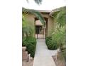 View of front porch gate entrance with desert landscaping at 2585 E Carob Dr, Gilbert, AZ 85298