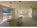 Unfinished spacious living room with natural light, sliding doors and multiple windows at 26119 N 23Rd Ave, Phoenix, AZ 85085