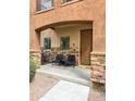 Inviting front porch with stone columns, outdoor seating, and a cozy welcome mat at 2821 S Skyline Dr # 156, Mesa, AZ 85212
