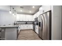 Bright kitchen with white cabinets, stainless steel appliances, granite countertops, and modern flooring at 2821 S Skyline Dr # 156, Mesa, AZ 85212