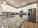 A chef's kitchen featuring stainless steel appliances, granite countertops, and ample cabinet space at 2821 S Skyline Dr # 156, Mesa, AZ 85212