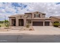 A charming two-story home featuring a three-car garage, a well-manicured front yard, and an inviting entrance at 3053 S Canfield --, Mesa, AZ 85212