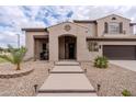 Inviting entrance featuring a walkway with landscape lighting, desert landscaping, and covered porch at 3053 S Canfield --, Mesa, AZ 85212