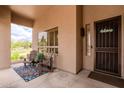 Relaxing front porch with seating area and a view of the landscaped front yard at 3053 S Canfield --, Mesa, AZ 85212