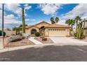 Charming single-story home featuring a two-car garage, desert landscaping, and a red tile roof at 3700 N 149Th Ln, Goodyear, AZ 85395