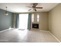 Living room with tile floors, fireplace and ceiling fan at 3930 W Monterey St # 115, Chandler, AZ 85226
