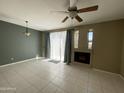 Living room with tile floors, fireplace and ceiling fan at 3930 W Monterey St # 115, Chandler, AZ 85226