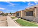 Exterior view showing the front of the home and sidewalk, with desert landscaping at 4836 W Rose Ln, Glendale, AZ 85301