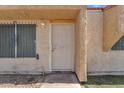 A close up view of the front door and the surrounding stucco walls at 4836 W Rose Ln, Glendale, AZ 85301