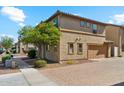 Side view of home showing garage, brick paver driveway, and mature shade tree at 523 N Ranger Trl, Gilbert, AZ 85234