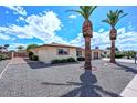 Well-maintained home with desert landscaping and two palm trees, showing nice curb appeal at 6041 E Colby St, Mesa, AZ 85205