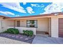 Inviting front porch showcases desert landscaping and wrought iron accents, a cozy entryway at 6041 E Colby St, Mesa, AZ 85205