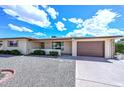 Ranch-style house features a two-car garage, desert landscaping, and neutral color palette at 6041 E Colby St, Mesa, AZ 85205