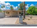 Inviting home exterior with a covered carport, mailbox, and desert landscaping at 617 W Gibraltar Ln, Phoenix, AZ 85023