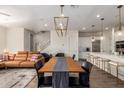 Open-concept living space with dining area, leather sofa, and staircase at 7343 E Casitas Del Rio Dr, Scottsdale, AZ 85255