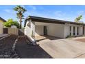 Exterior of a home highlighting its covered carport, xeriscaped yard, and clean, modern design at 845 E Village Circle S Dr, Phoenix, AZ 85022