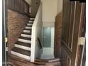 Inviting entryway featuring a staircase, brick accents, and wood-look floors at 921 S Val Vista Dr # 28, Mesa, AZ 85204