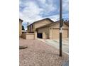 Two-story home featuring tan siding, a two-car garage and a low-maintenance gravel yard at 921 S Val Vista Dr # 28, Mesa, AZ 85204