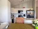Bright kitchen featuring white cabinets, stainless steel appliances, and modern countertops at 921 S Val Vista Dr # 28, Mesa, AZ 85204