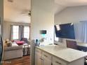 Cozy living room with neutral-toned furniture, a large TV, and a view into the kitchen at 921 S Val Vista Dr # 28, Mesa, AZ 85204