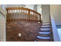 Second-floor loft area with a railing, brick accents and access to upper rooms at 921 S Val Vista Dr # 28, Mesa, AZ 85204