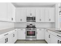 Bright kitchen showcasing white cabinets, modern stainless steel appliances, and subway tile backsplash at 9728 E Twinkle Ave, Mesa, AZ 85212