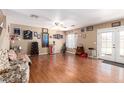 Spacious living room with wood floors, ceiling fan, and French doors to the backyard at 12430 W Scotts Dr, El Mirage, AZ 85335