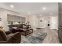 Bright living room with a comfortable seating area, neutral tones, and access to other rooms at 14616 N 28Th Pl, Phoenix, AZ 85032