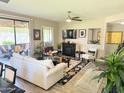 Well-lit living room features a fireplace, ceiling fan, and a sliding door to an outdoor seating area at 15252 N 100 St # 1146, Scottsdale, AZ 85260