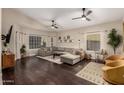 Spacious living room with dark hardwood floors, a large sectional sofa, and plenty of natural light at 16014 S 13Th Way, Phoenix, AZ 85048