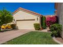Beautiful single Gathering home featuring a two-car garage, terra cotta roof, and well landscaped front yard at 1700 E Lakeside Dr # 64, Gilbert, AZ 85234